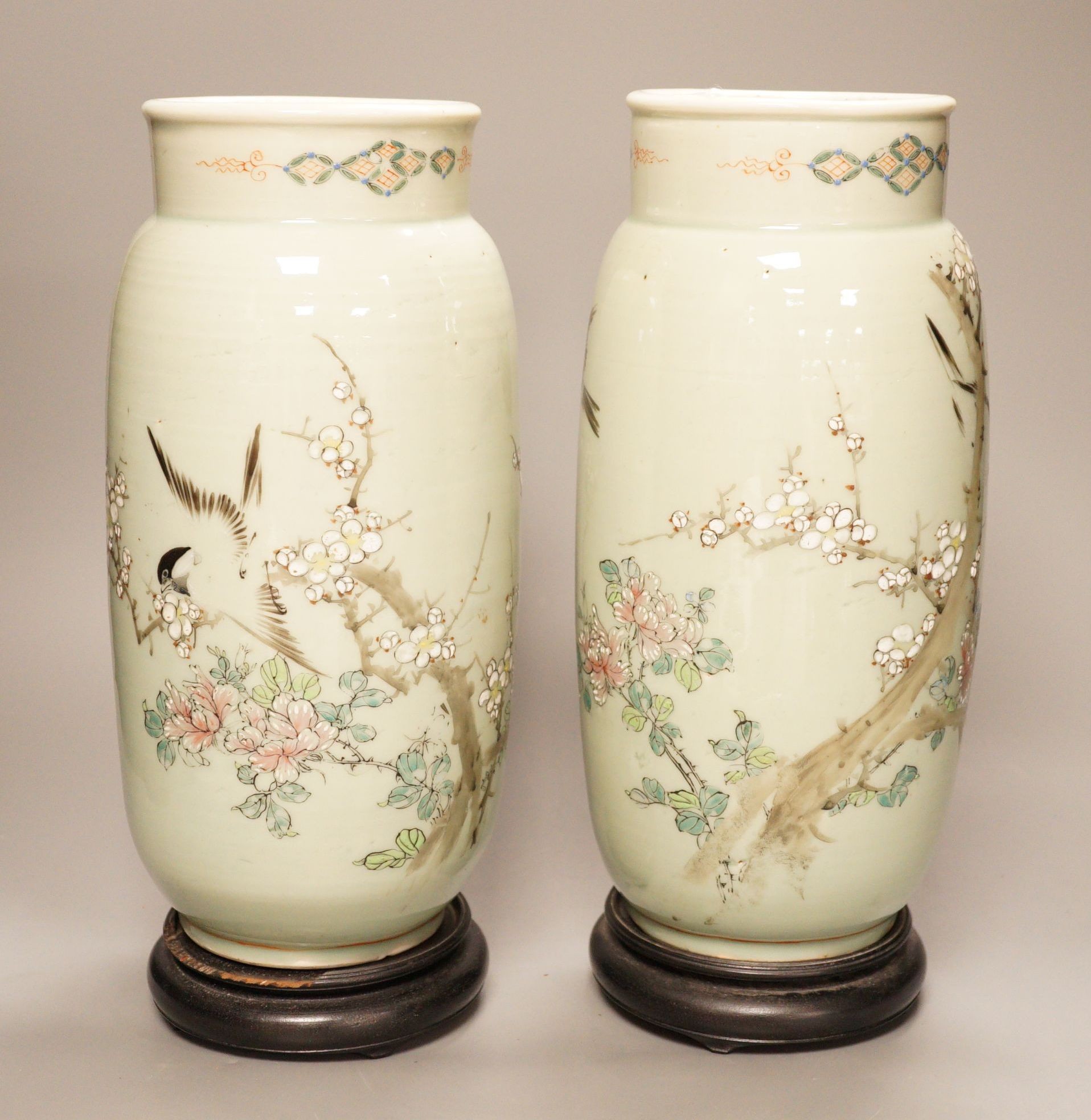 A pair of 19th century Japanese celadon glazed vases (drilled) with hardwood stands, total height 31cm